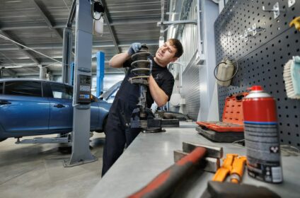 Car spare parts. Replacement of the front spring and shock absorber on a passenger car at the servic
