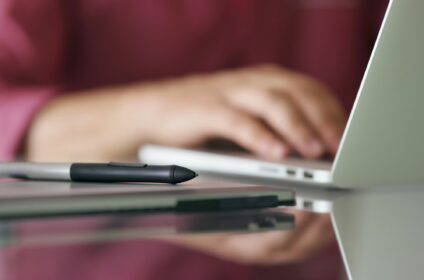 Designer Using Grafic Tablet And Laptop Writes On Keyboard