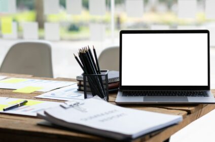 Laptop on desk and office equipment.
