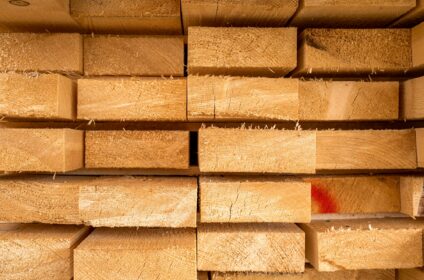 Stack of lumber wooden beams prepared to build a house