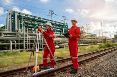 Team survey construction engineer with safety jacket use level survey camera. Engineer