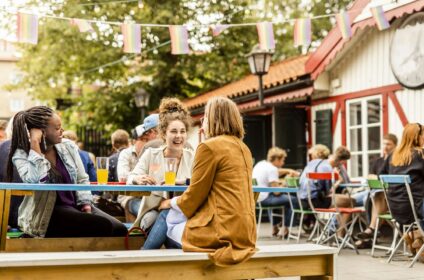 Young female friends relaxing in beer garden